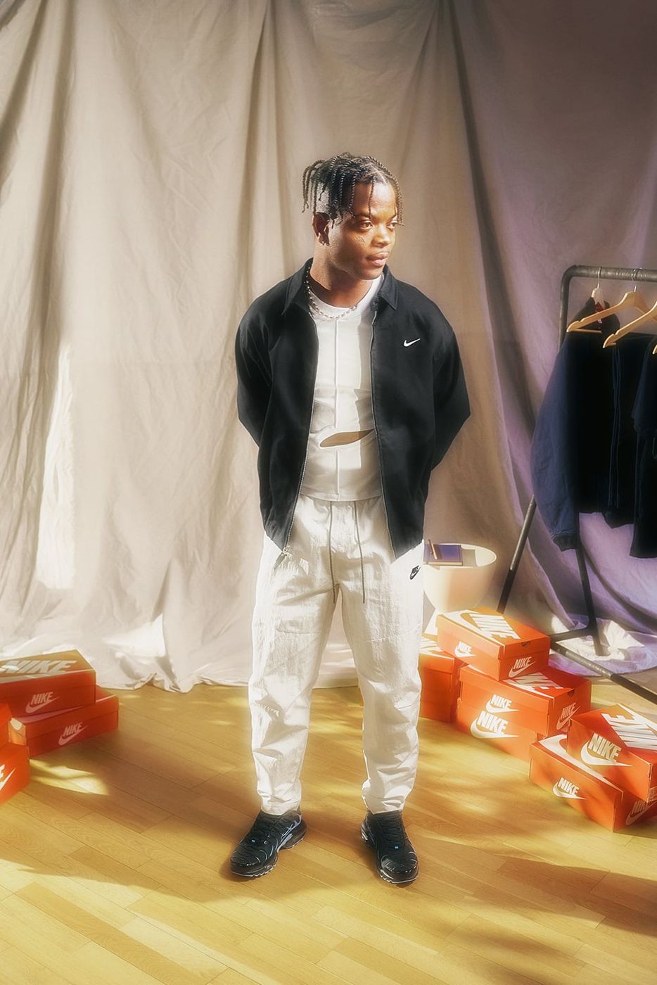 Taofeek Abijako standing in black Nike jacket