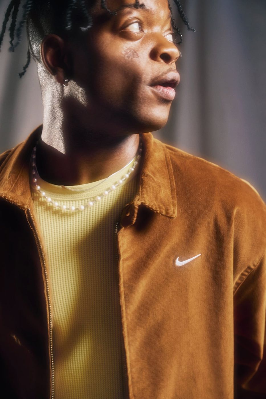 Close portrait of Taofeek Abijako in brown corduroy jacket