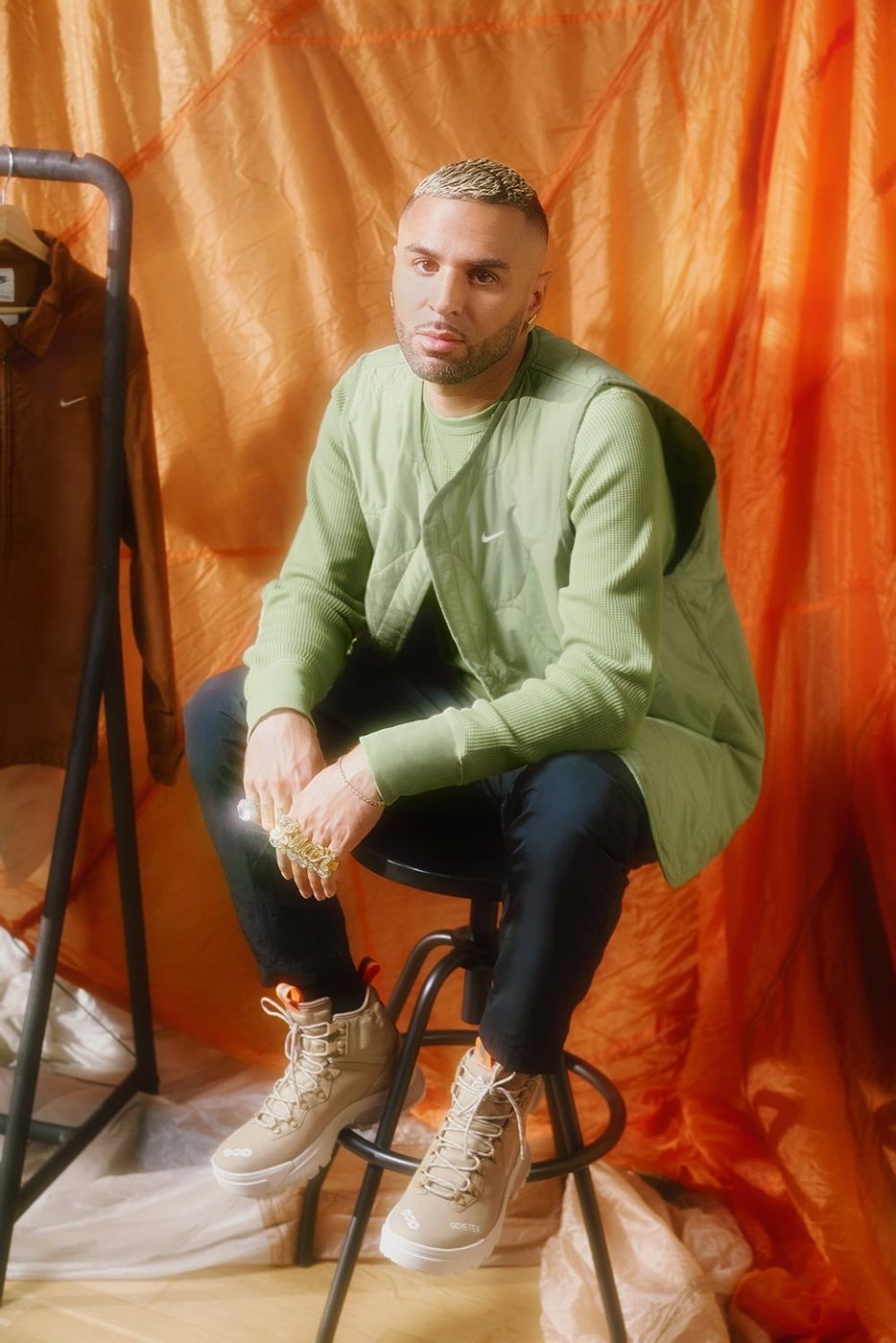 Raul Lopez seated in green Nike sweater
